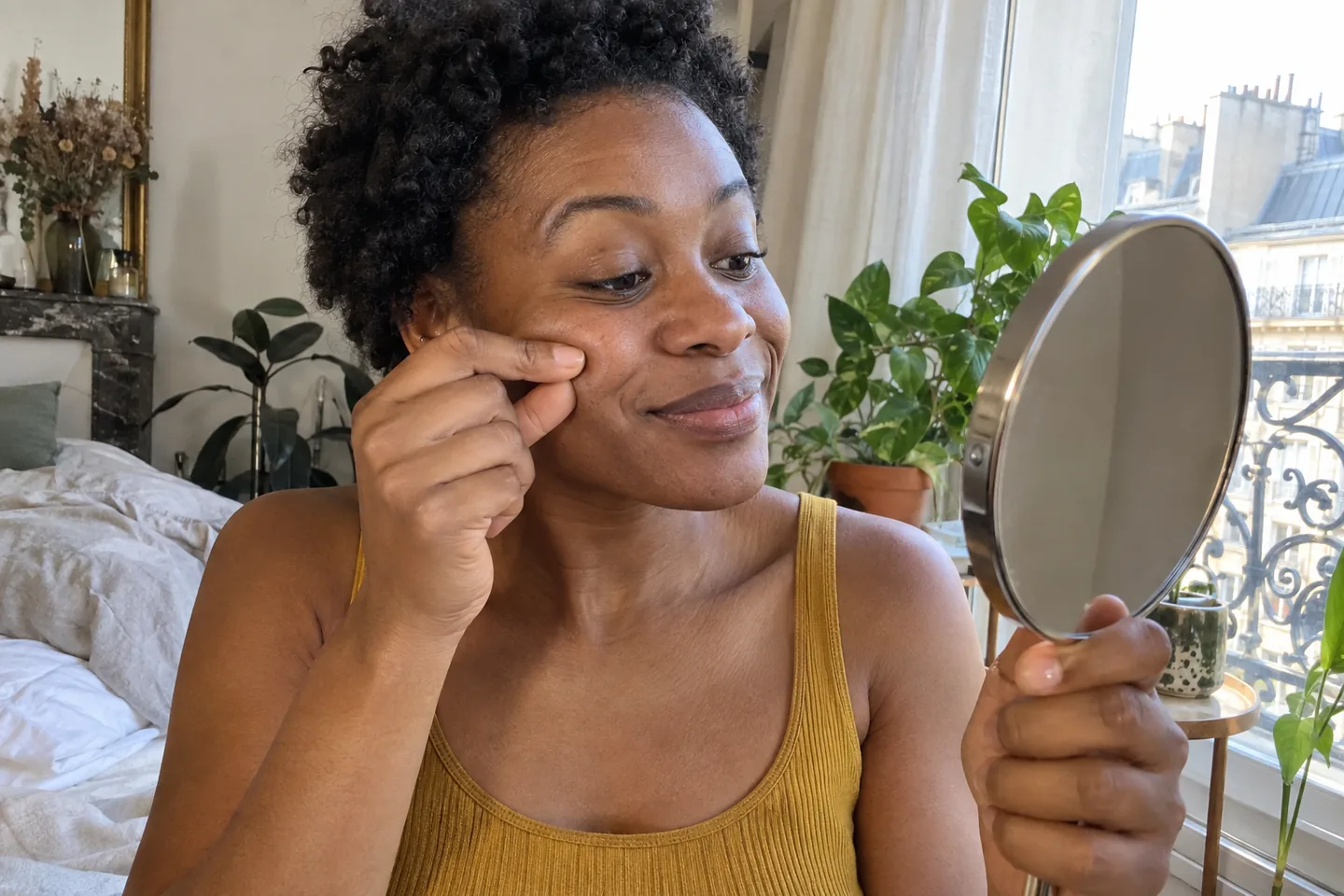 Une femme pince doucement la peau de sa pommette pour réaliser le test du pincement